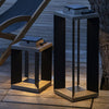 Wooden lounge chair on a wooden deck with two modern outdoor solar lamps.