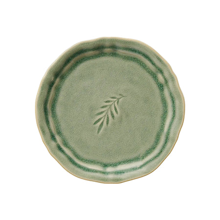 A round, antique-style stoneware plate with a green glaze and a leaf design in the center.
