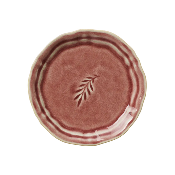 A round, old rose colored ceramic plate with a unique glaze effect, suitable for snacks or as a side plate.
