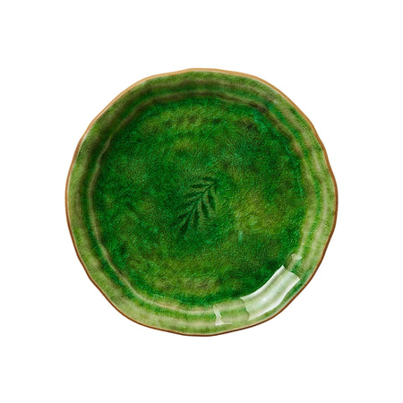 A round ceramic plate with a green speckled effect and a central leaf design, on a white background.