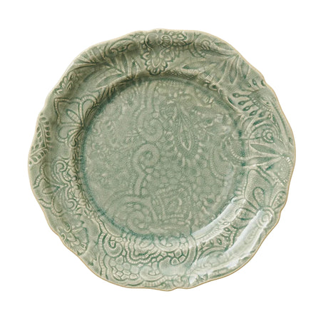Decorative green ceramic plate with intricate patterns on a white background