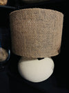 Lamp with burlap shade on a dark background