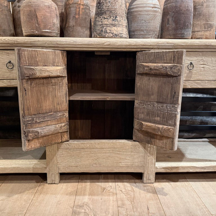 Old pine console with open doors on a wooden floor