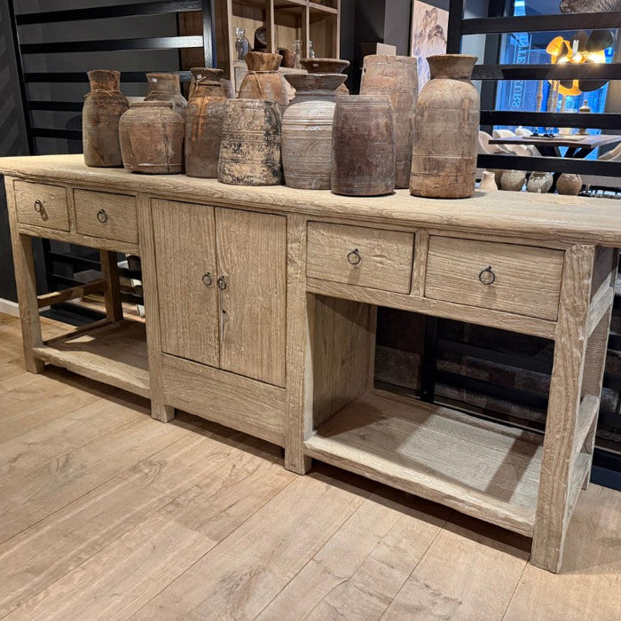 Wooden console table with decorative vases in a room setting