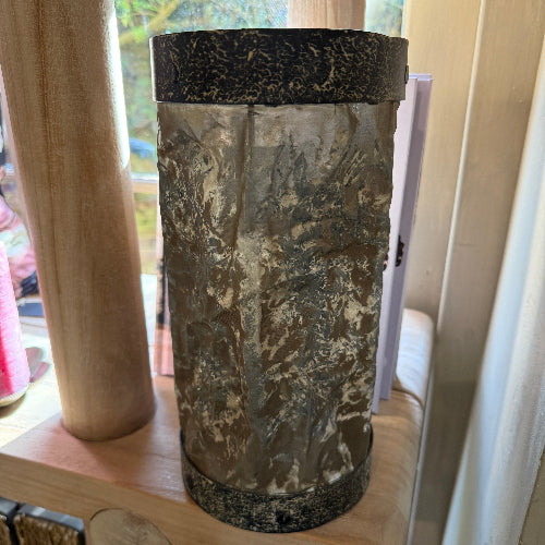Drum shaped candleholder made from metal and parchment-like fabric