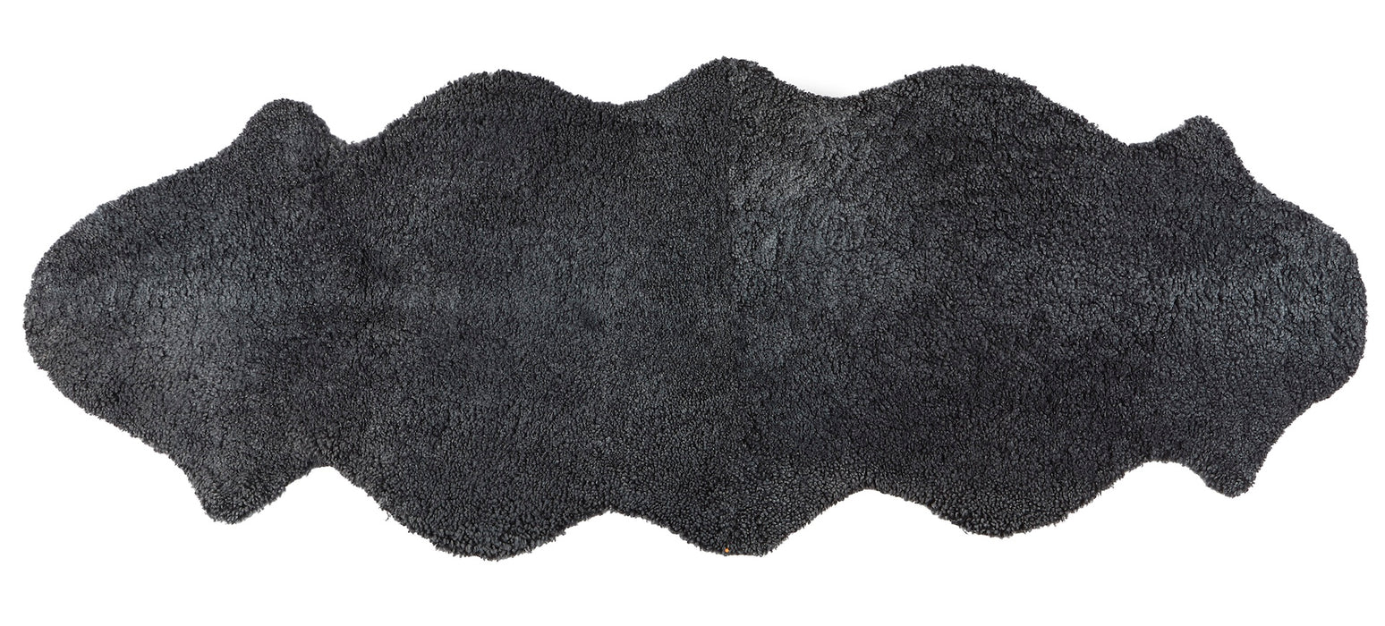 Natural double sheepskin in black on a white background.