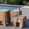 Gommaire teak Doblo side tables by a poolside with a book and cup on top