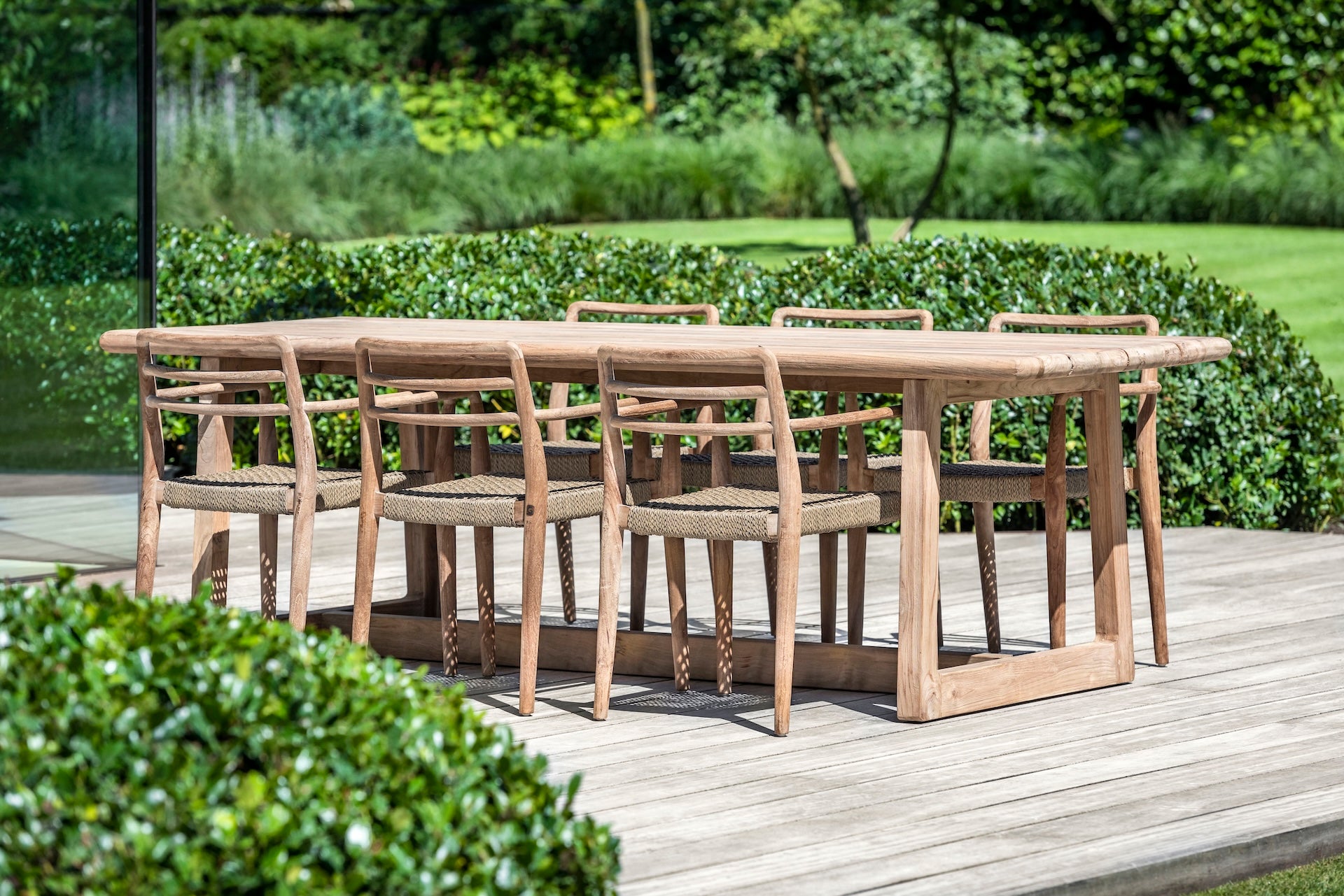 Wooden outdoor dining table with chairs on a patio