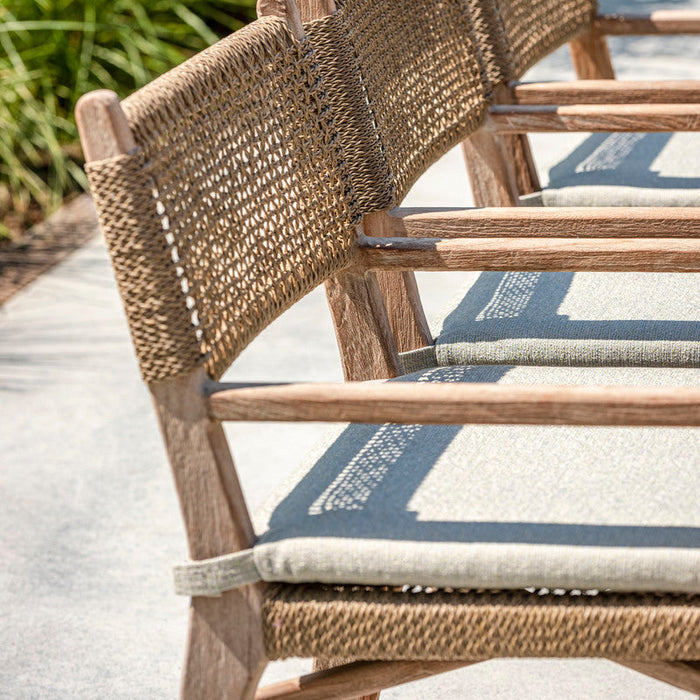 Wicker chairs with cushions on a patio