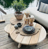 Trio of teak coffee tables in a lakeside setting with sofa 