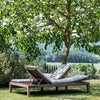 Double teak sunlounger in garden under tree