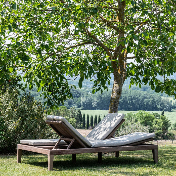 Double teak sunlounger in garden under tree