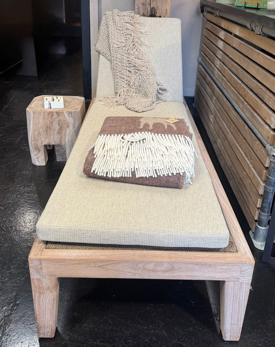 Teak lounge chair with cushions in a room setting