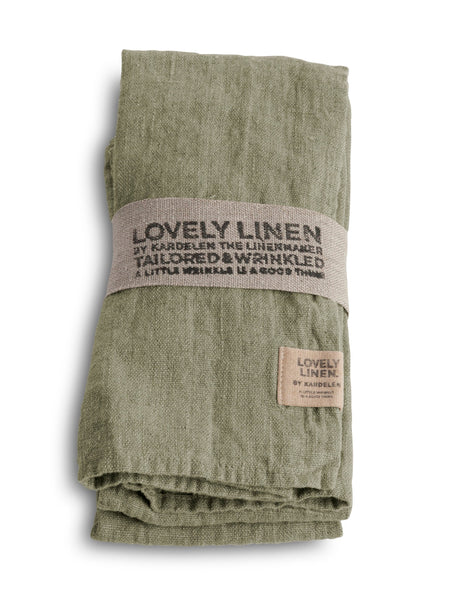A pack of four green linen napkins tied together with a label that reads 'Lovely Linen Tailored Wrinkled' and a brand tag.