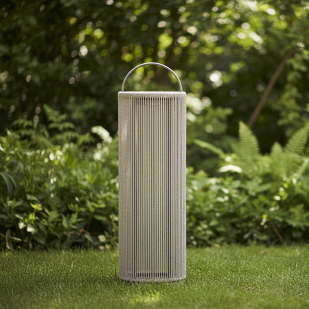 A tall cylindrical outdoor lantern with a woven beige rope body, a silver metal top handle, and a silver metal base, shown on a solid white background.