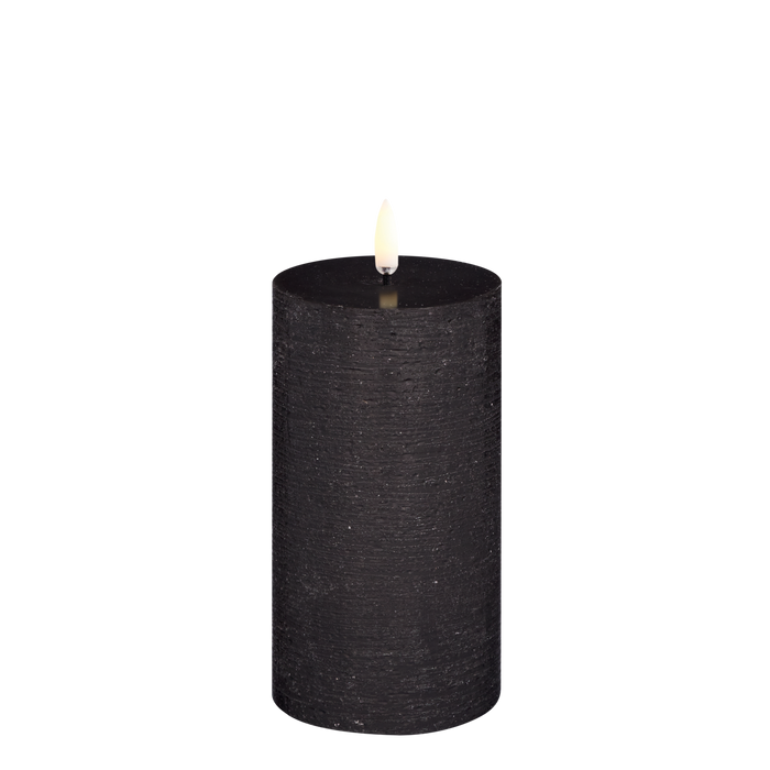 Black LED pillar candle with rustic finish on a white background.