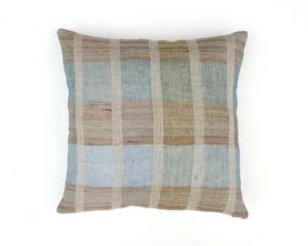 A cushion with a plaid pattern featuring shades of denim blue, sea green, and tobacco brown, made from linen and silk.