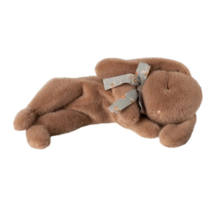 Soft brown plush sleeping bunny with bow on white background