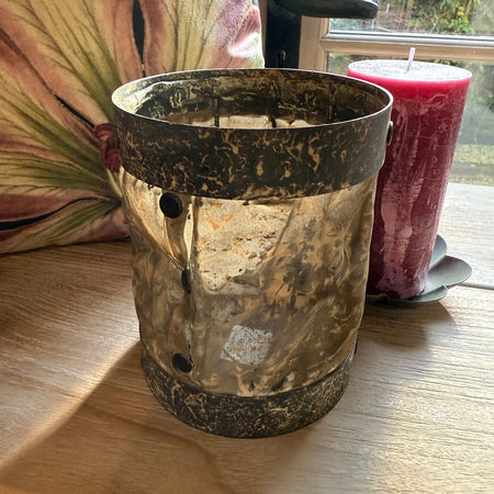 Candleholder made from metal and textured silk with button detail casting a beautiful soft glow