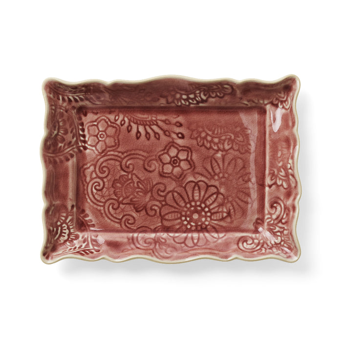 A rectangular ceramic appetizer plate with a floral old pink glaze and intricate detailing along the edges.