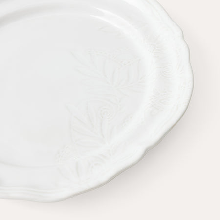 Close up of white ceramic dinner plate with decorative glaze