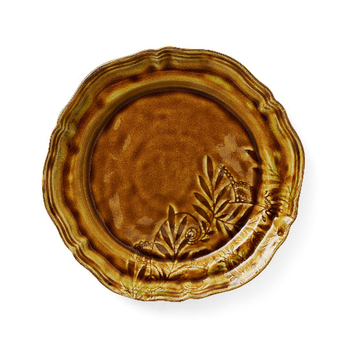 Brown ceramic plate with leaf patterns on a white background