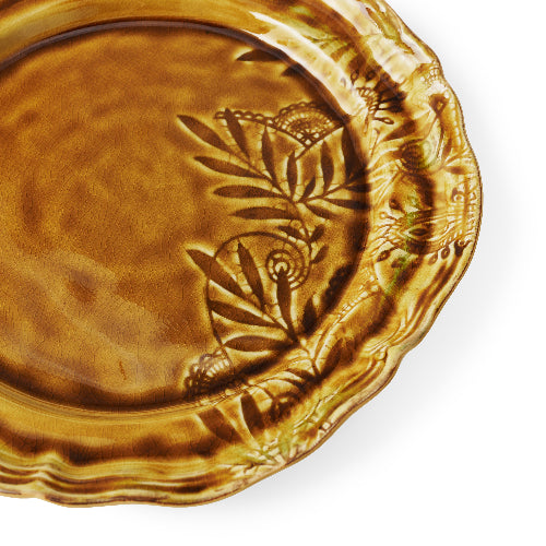 Decorative ceramic plate with leaf design on a white background